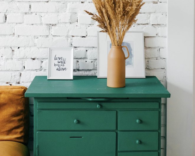 Image of drawers a sofa and a vase